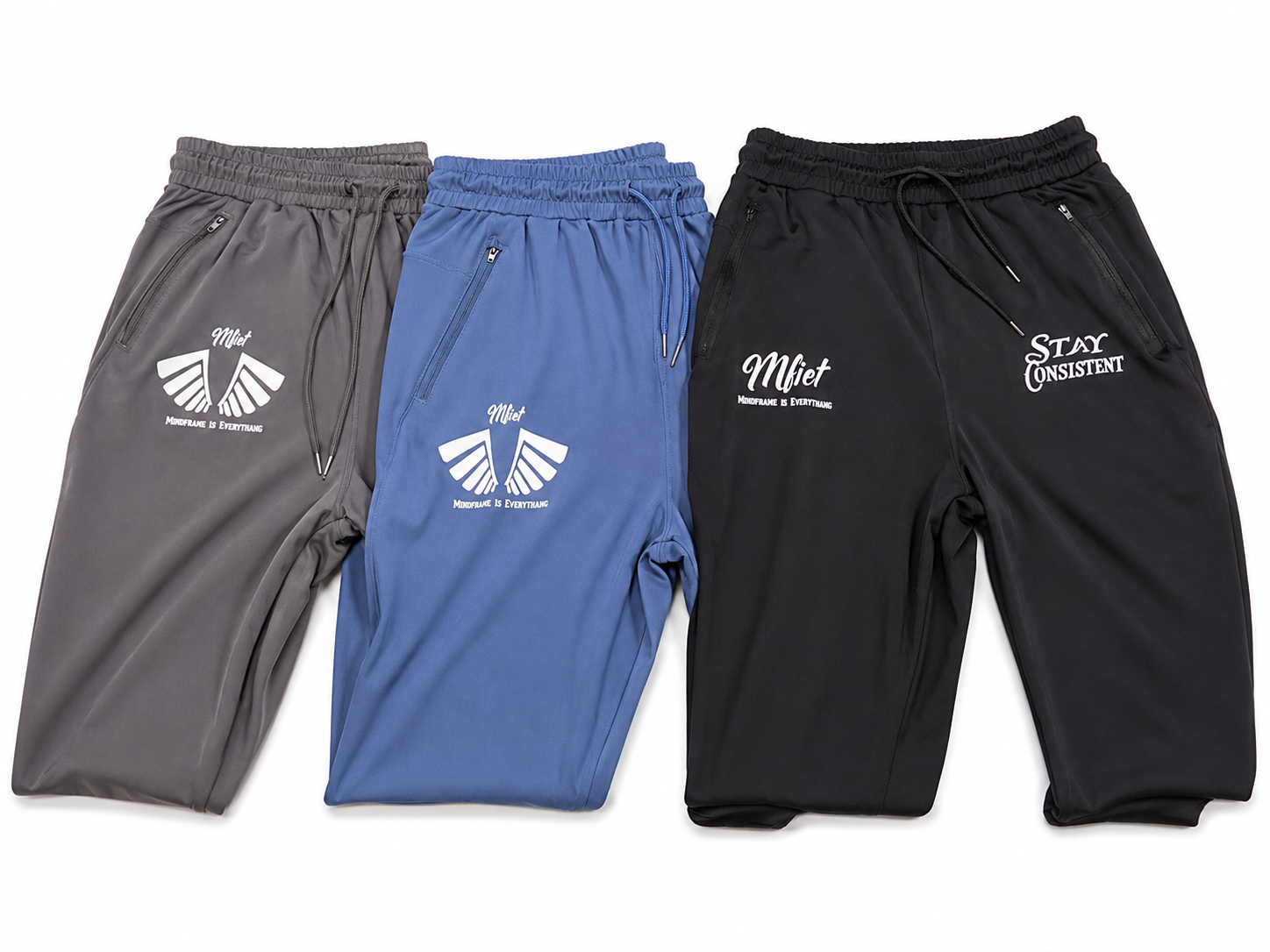 MFIET Stay Consistent performance joggers collection showing Mastermind Black, Vision Blue, and Clarity Grey colorways with reflective branding.